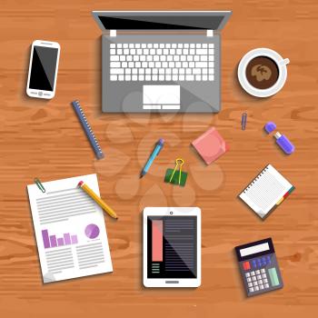 Top view of business people workplace with laptop, digital tablet, smartphone and different office elements on wood table