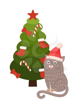 Greeting card cartoon cat in Santa s hat sitting under Christmas tree decorated by socks, candy stripped sticks, red bows and topped by star vector