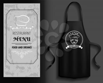 Black apron next to piece of paper with menu. Clothes for work in kitchen, protective element of clothing for cooking. Apron for cooking in kitchen and protection of clothes near restaurant menu