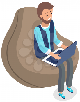 Man sitting in comfortable bag chair and browsing or working on laptop at his laps. Male character types on keyboard with computer, works remotely. Person is freelancing on laptop, online work