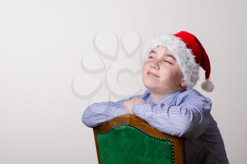 Boy in Santa Claus hat in dreams