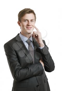 businessman attaching finger to the face is smiling and looking at the camera