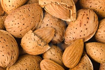 Pile of almonds close-up as background.