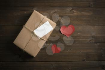 wrapped in kraft paper gift for Valentine's Day with red hearts