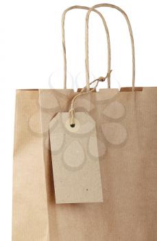 Shopping bag with tag isolated on white background. Close-up.
