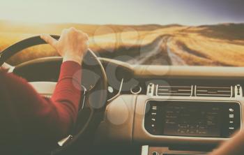 Driving and holding the steering wheel closeup,view from cockpit of the car