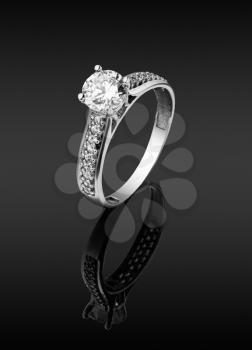 women's ring with diamonds on dark background