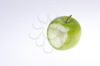 A eaten green apple isolated on a white background