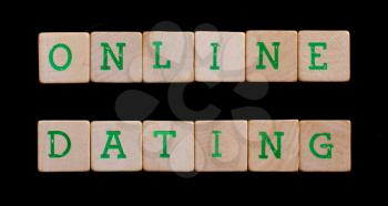 Green letters on old wooden blocks (online dating)