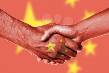 Man and woman shaking hands, wrapped in flag pattern, China