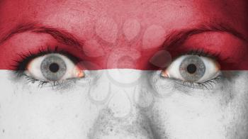 Close up of eyes. Painted face with flag of Indonesia