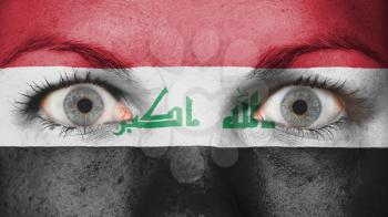 Close up of eyes. Painted face with flag of Iraq