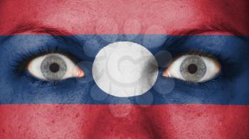 Close up of eyes. Painted face with flag of Laos