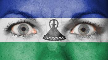 Close up of eyes. Painted face with flag of Lesotho