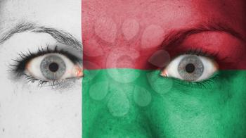 Close up of eyes. Painted face with flag of Madagascar