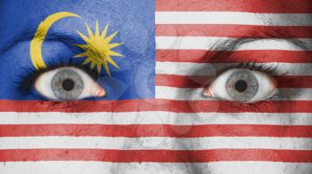 Close up of eyes. Painted face with flag of Malaysia