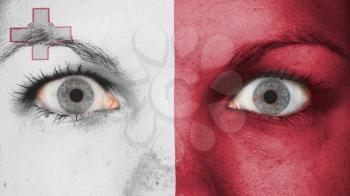 Close up of eyes. Painted face with flag of Malta