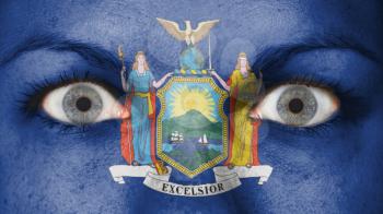 Close up of eyes. Painted face with flag of New York