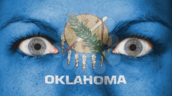 Close up of eyes. Painted face with flag of Oklahoma