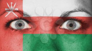 Close up of eyes. Painted face with flag of Oman