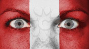 Close up of eyes. Painted face with flag of Peru