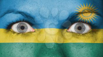 Close up of eyes. Painted face with flag of Rwanda