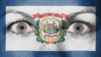 Close up of eyes. Painted face with flag of West Virginia