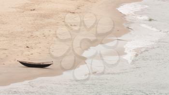 Abandoned wooden boat on a Vietnamese beach