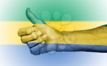 Old woman giving the thumbs up sign, isolated, flag of Gabon