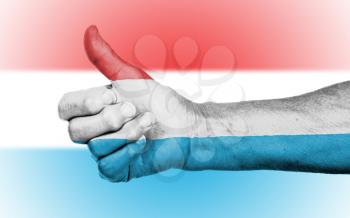 Old woman giving the thumbs up sign, isolated, flag of Luxembourg