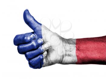 Old woman with arthritis giving the thumbs up sign, wrapped in flag pattern, France