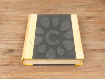 Old book isolated on a wooden table