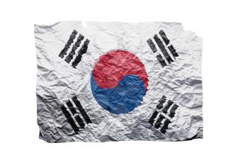 Close up of a curled paper on white background, print of the flag of South Korea