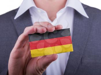 Businessman showing card, matte paper effect, Germany