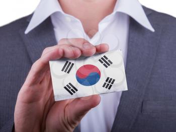 Businessman showing card, matte paper effect, South Korea