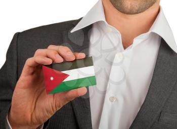 Businessman is holding a business card, flag of Jordan