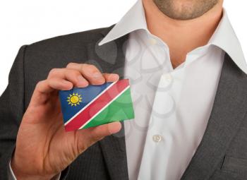 Businessman is holding a business card, flag of Namibia