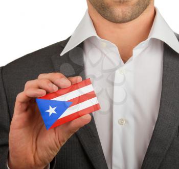 Businessman is holding a business card, flag of Puerto Rico