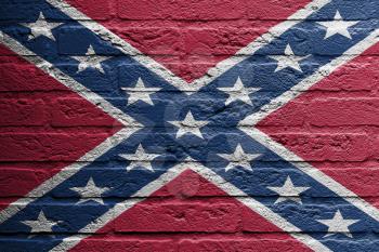 Brick wall with a painting of a flag isolated, confederate flag
