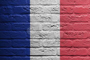 Brick wall with a painting of a flag isolated, France