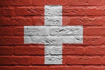 Brick wall with a painting of a flag isolated, Switzerland