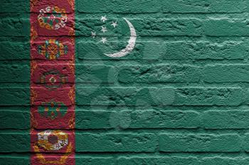 Brick wall with a painting of a flag isolated, Turkmenistan