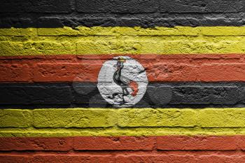 Brick wall with a painting of a flag isolated, Uganda