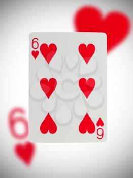 Playing card with a blurry background, six of hearts