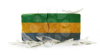 Brick with broken glass, violence concept, flag of Gabon