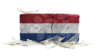 Brick with broken glass, violence concept, flag of the Netherlands