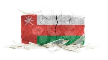 Brick with broken glass, violence concept, flag of Oman