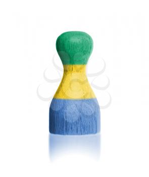 Wooden pawn with a painting of a flag, Gabon