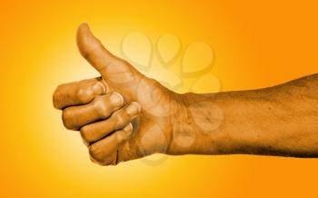 Old woman with arthritis giving the thumbs up sign, orange skin