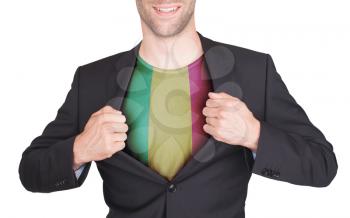 Businessman opening suit to reveal shirt with flag, Mali
